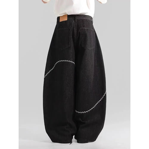 Black straight-leg denim trousers for teenagers on a hanger, showing mid-waist and zip fly detail.