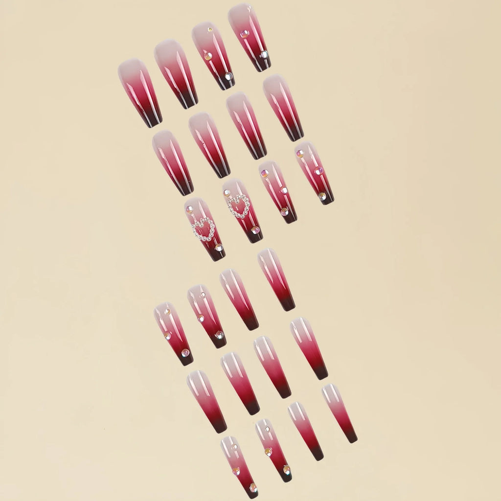 Wine red gradient fake nail tips with pearl heart design in a long ballet style.