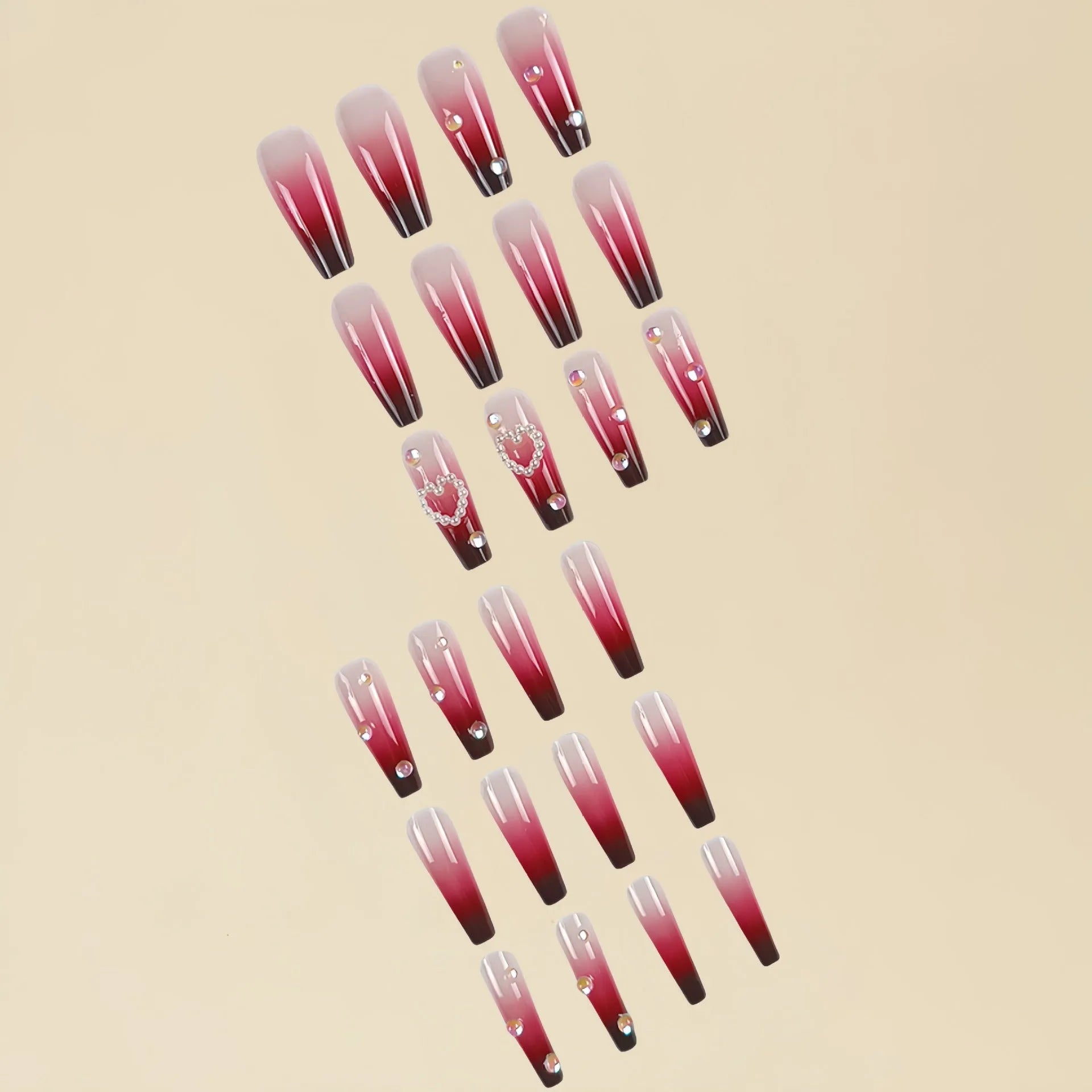 Wine red gradient fake nail tips with pearl heart design in a long ballet style.