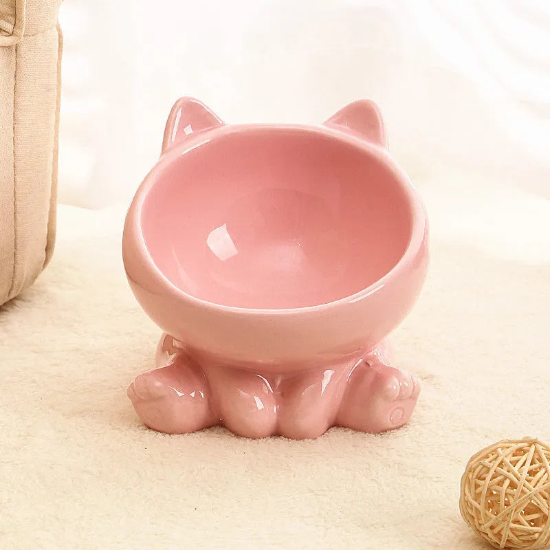 Ceramic cat bowl with neck guard in black and white and pink and blue colour options on a white background