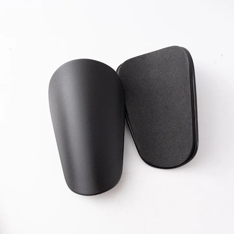 PU mini shin guards for football and sports in black, white, red, and blue colours.