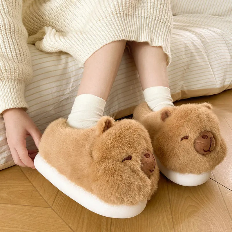 Light brown women's plush winter slippers with a round toe and slip-on design on a white background.