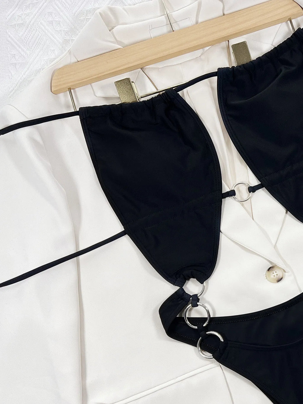 Solid black women's one-piece sleeveless swimsuit made from nylon fabric.