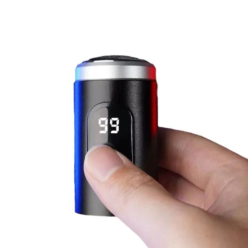 Black mini portable rechargeable shaver with USB cable and cleaning brush on a white background.