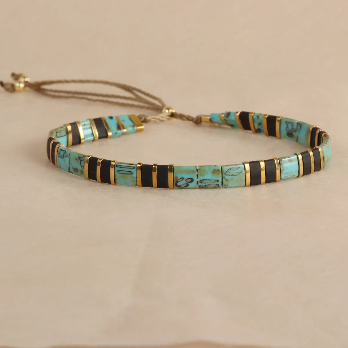 Geometric glass pull bead bracelet in five colour options on wrist