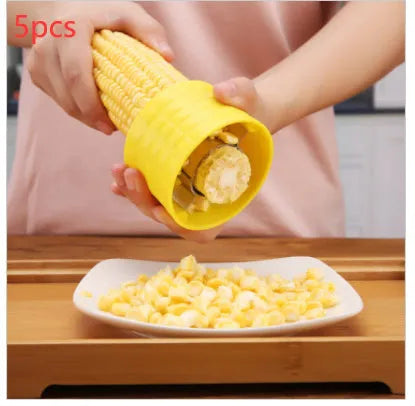 Yellow manual corn grinder thresher with corn-shaped design and PP plastic grip.