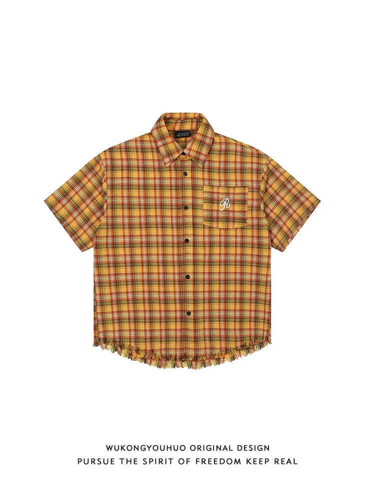 Yellow plaid loose fit short sleeve shirt with embroidered detail on the chest pocket.