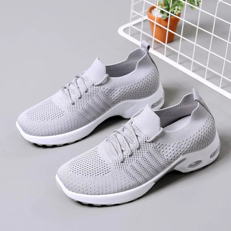 Women's black casual sneakers with mesh upper, lace-up front and soft PVC sole