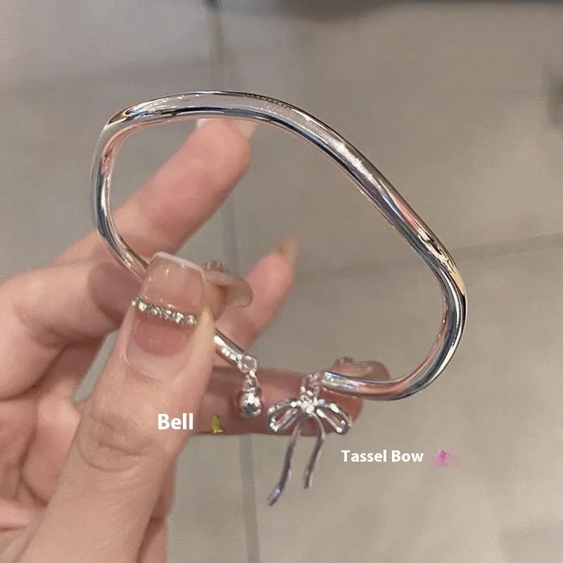 Silver adjustable bracelet with bow charm and bow bell opening clasp