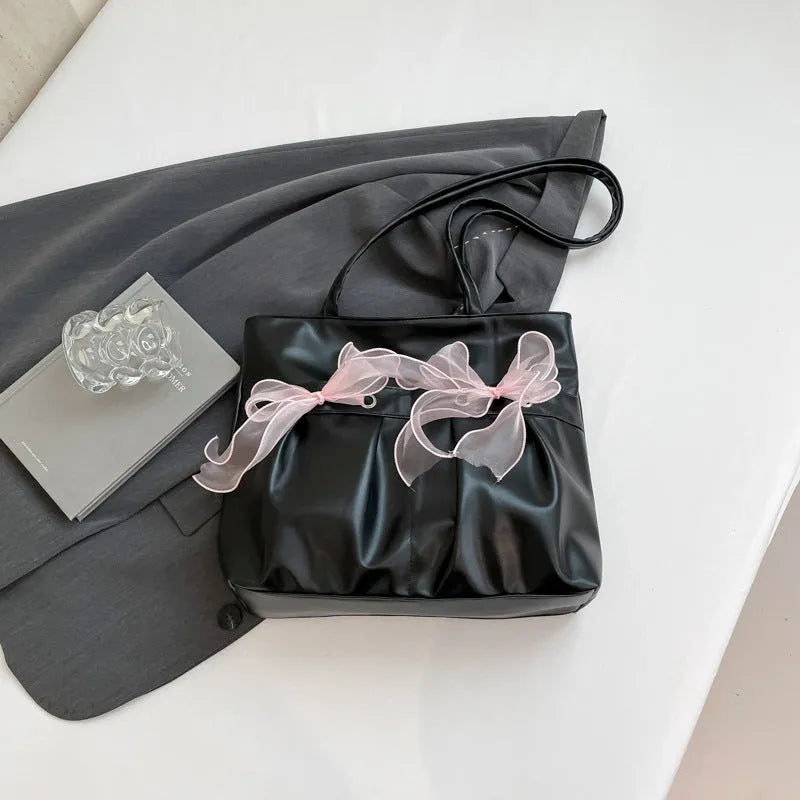 College style large capacity black tote bag with bow detail and double shoulder straps.