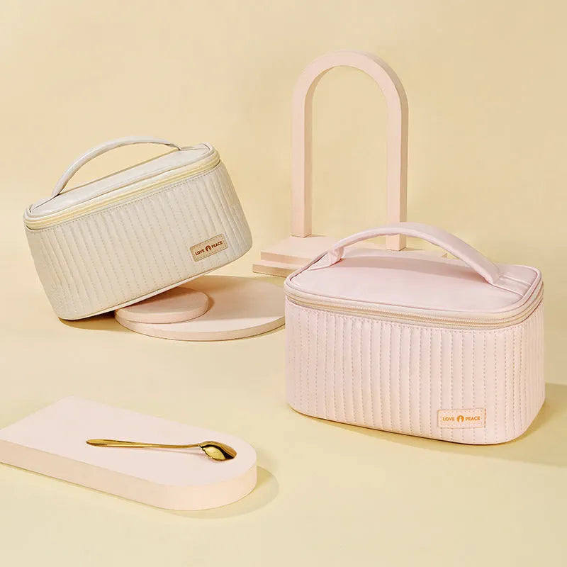 Open-top cake shaped makeup bag in solid colour PU leather, shown in a light blue colour variant.