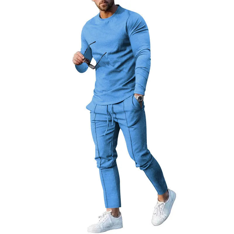 Man wearing a light grey round-neck long-sleeve t-shirt and matching trousers from a two-piece polyester suit set.