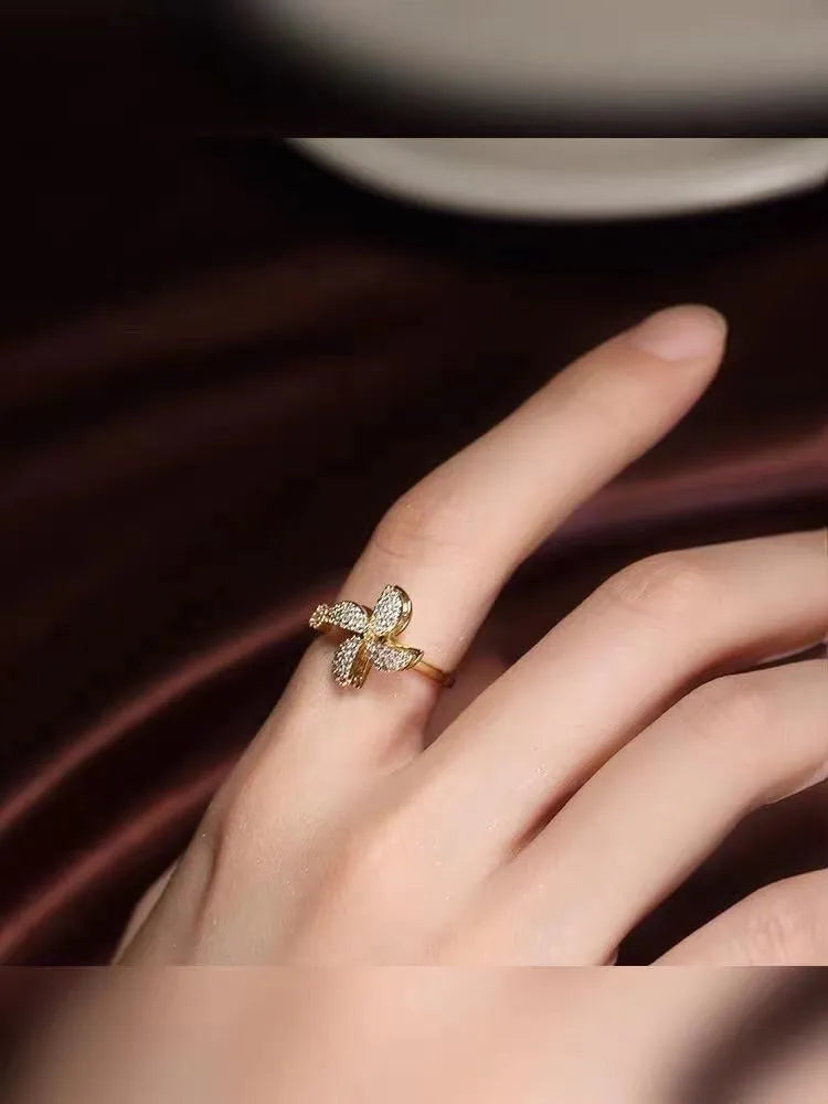 Rotating geometric ring with micro-inlaid windmill design in gold or silver electroplated finish