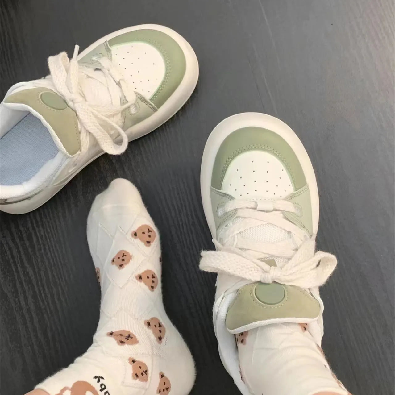 Green women's flat casual sneakers with a round toe and breathable PU mesh upper.