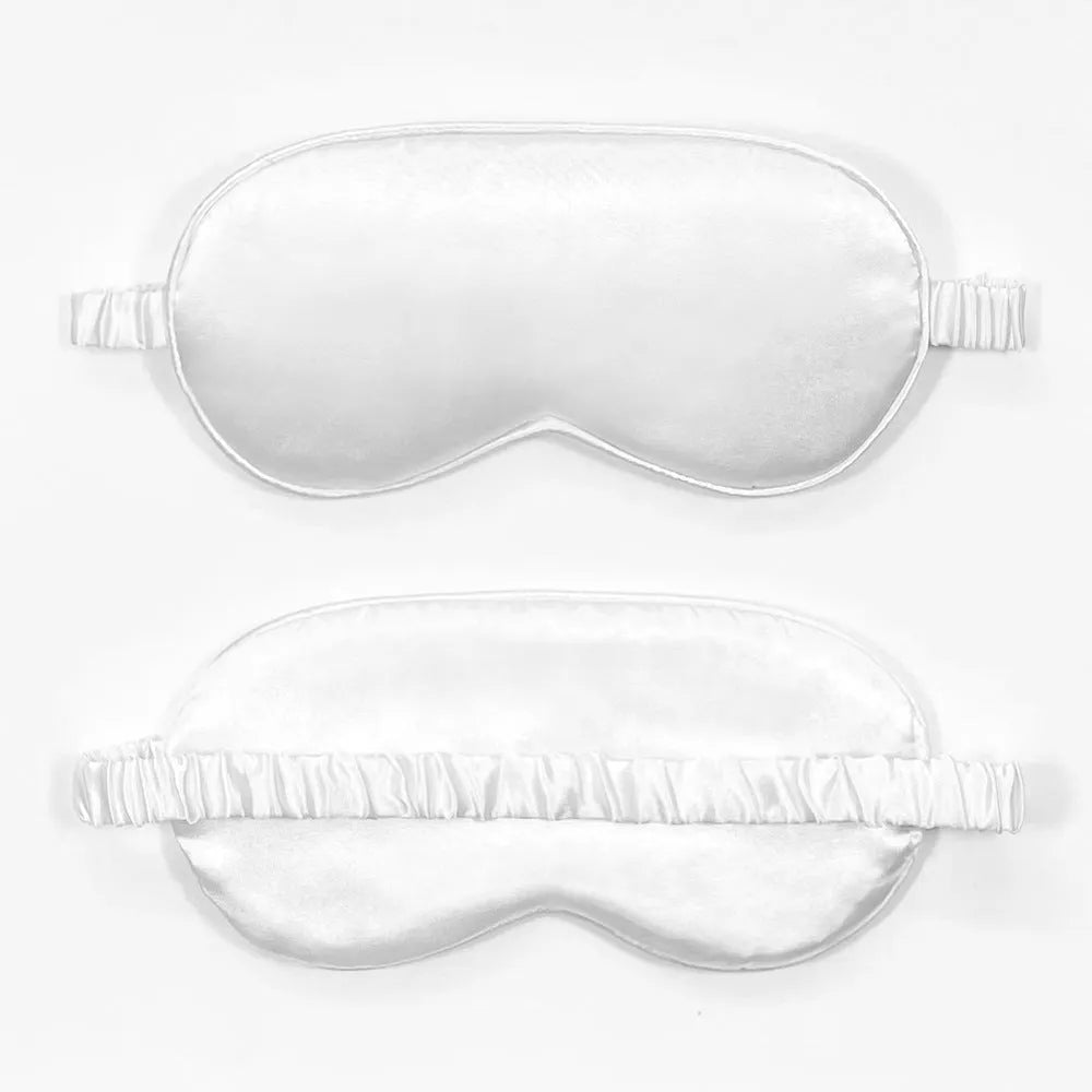 Reversible silk-like sleep eyeshade shown in multiple colour options including sky blue, wine red, and black.
