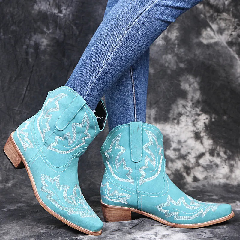 Women's blue embroidered Western cowgirl boots with a low wedge heel and pointed toe.