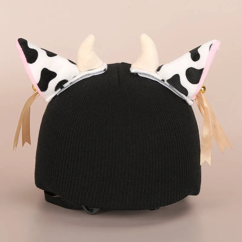A plush fabric cartoon character helmet hat cover with attached ears on a white background.