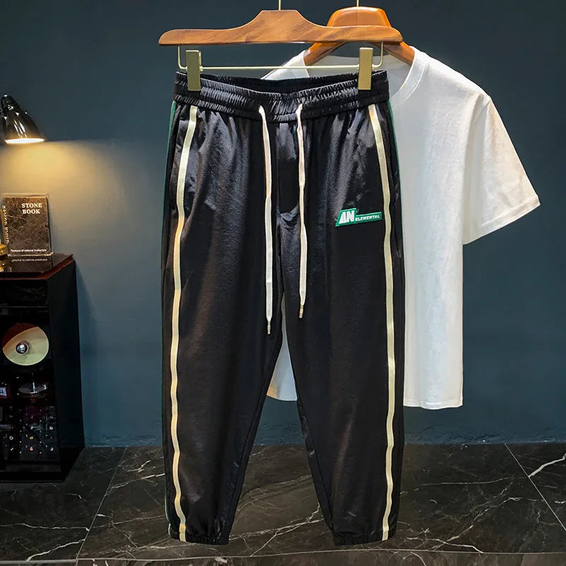 Men's black harem pants with mid-waist fit and trousers length made from ice silk cotton blend fabric