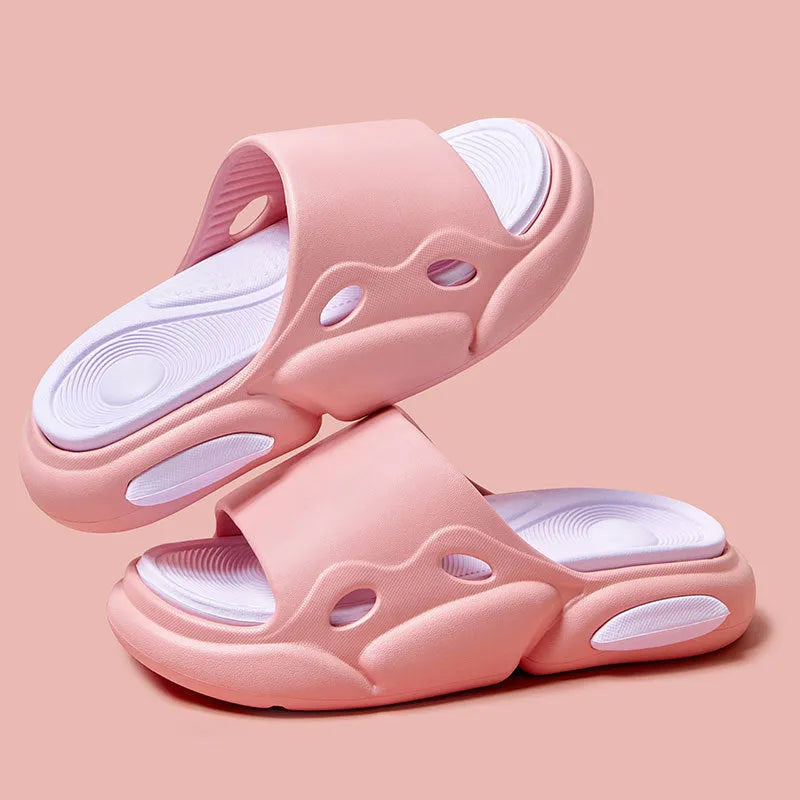 Two-colour thick-soled EVA slippers for couples on a floor, showing pink and purple or black and white colour options.
