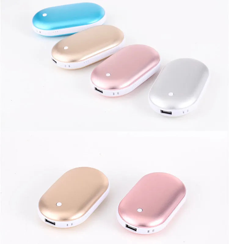 Compact rose gold USB rechargeable hand warmer and power bank with digital display on a wooden table.