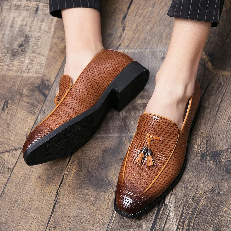 Men's black pointed toe slip-on shoes with a tassel detail on the vamp
