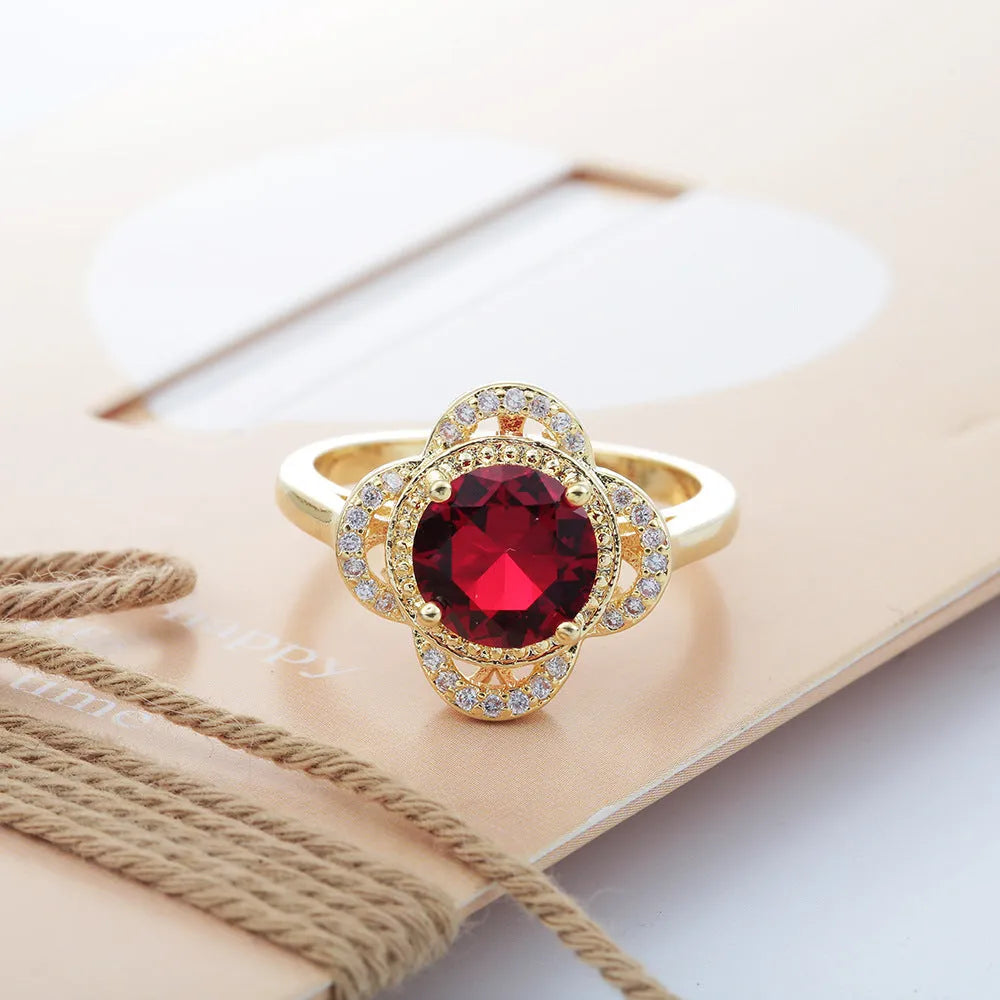 Copper fruit-shaped ring with zircon inlay in electroplated 10-6-1395 colour on a finger.