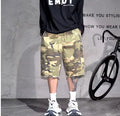 Men's loose-fit camouflage print shorts in retro workwear style on a white background.