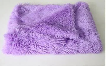 Long plush pet blanket in wool polyester blend showing dark grey, light grey and white colour options with size comparison