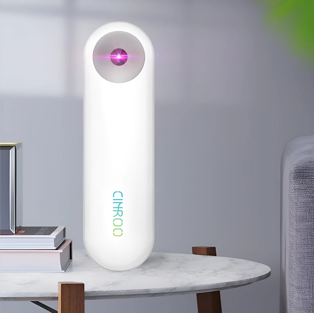 White portable UV sterilizer lamp for disinfecting mobile phones and small items.