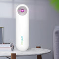 White portable UV sterilizer lamp for disinfecting mobile phones and small items.