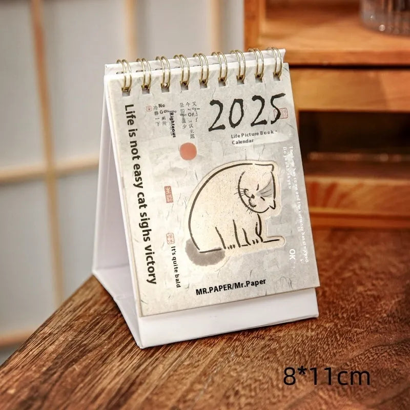 Mini A5 desk calendar 2025 showing one of eight themed designs in simple modern style