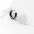 Silver geometric twist earrings with striped pattern and round sports style elements