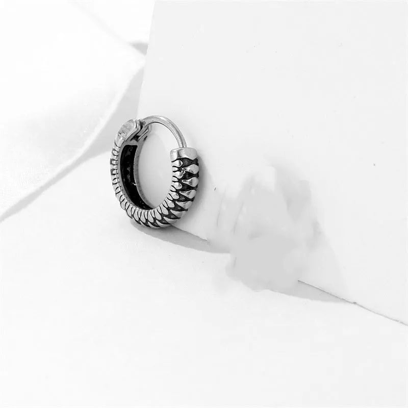 Silver geometric twist earrings with striped pattern and round sports style elements