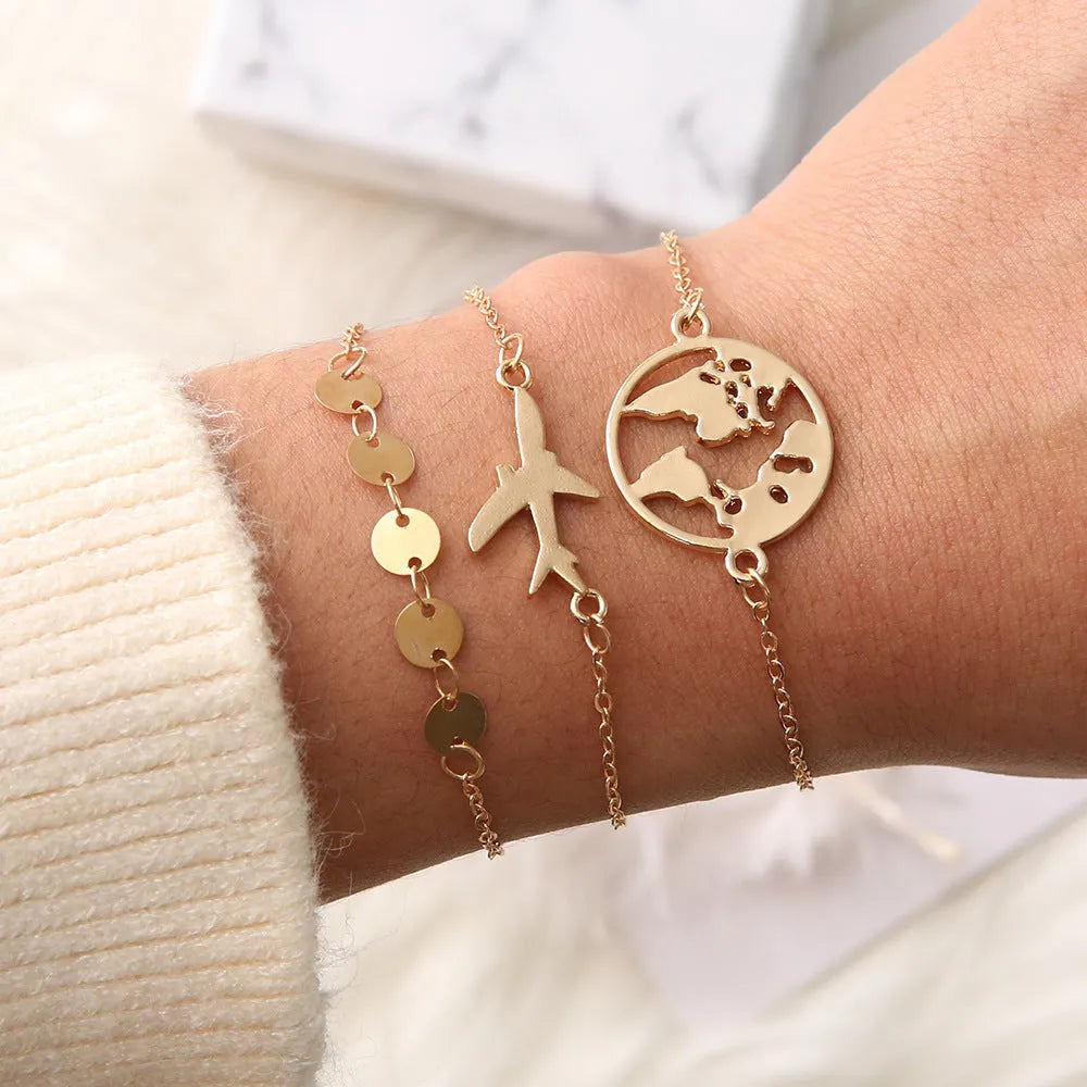 Three Bohemian-style bracelets with aircraft map charms and heart shapes in electroplated alloy