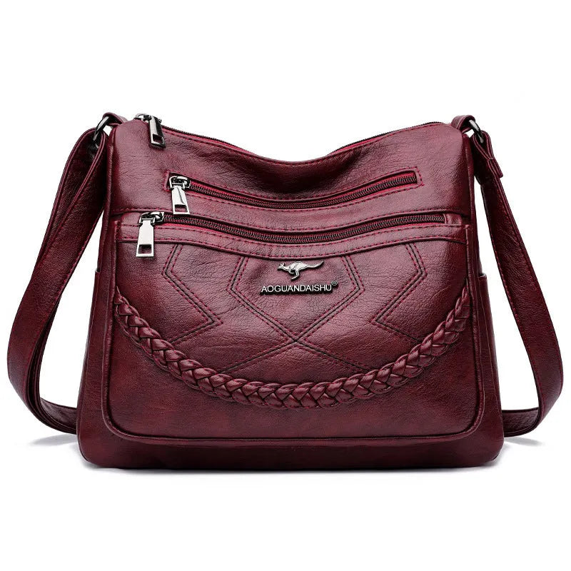 Soft PU leather shoulder bag in horizontal square shape, shown in one of four colours with crossbody strap