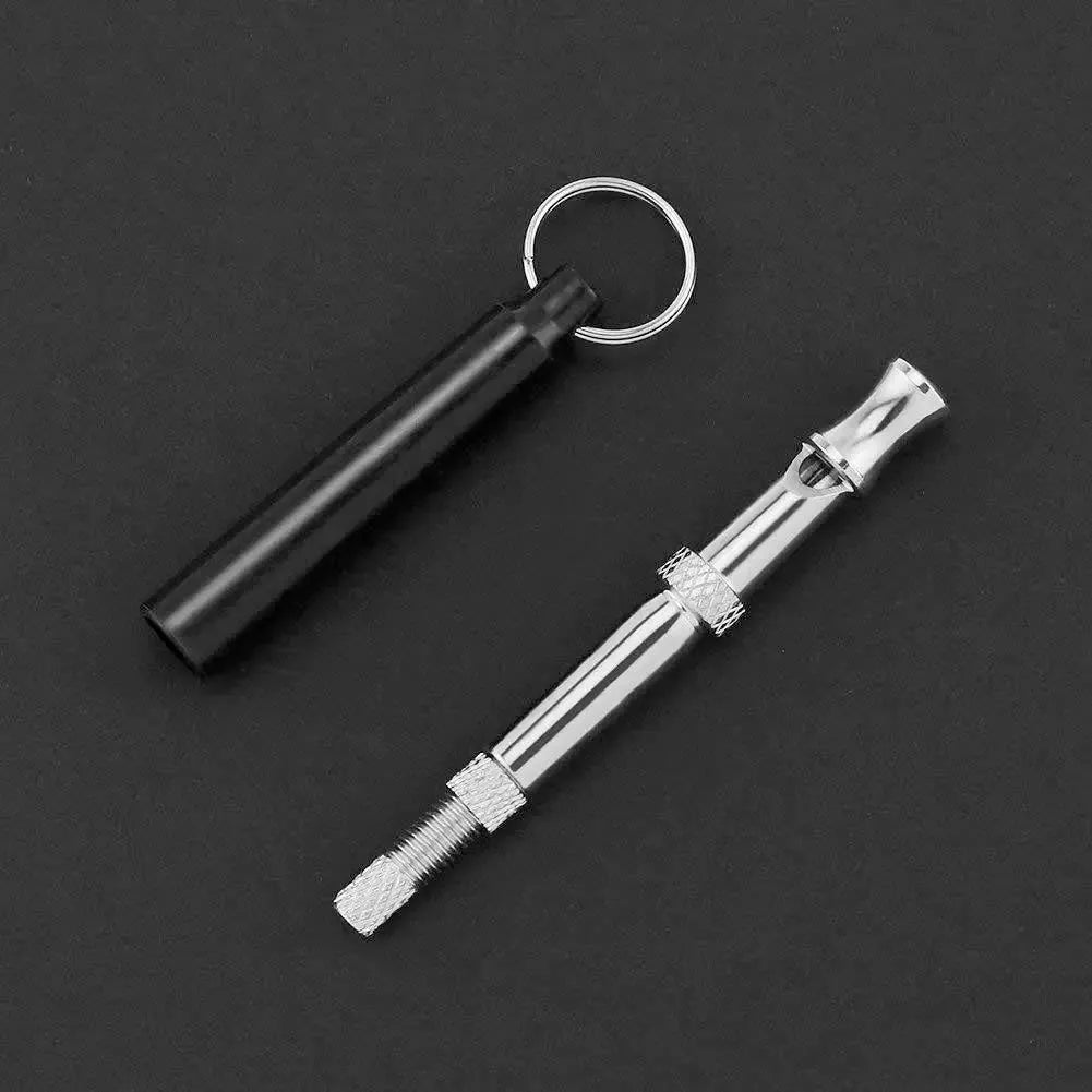 Copper ultrasonic dog training whistle with keychain cord and iron ring in black colour on white background