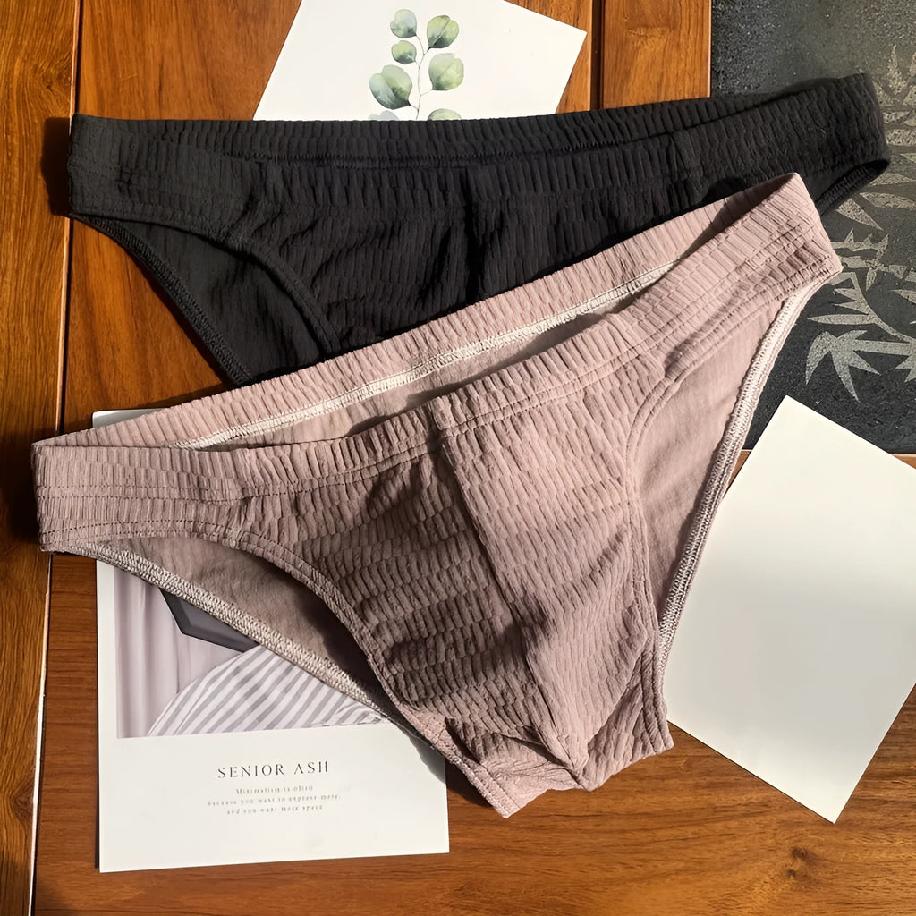 Men's solid colour cotton briefs with a mid waist and triangle design.