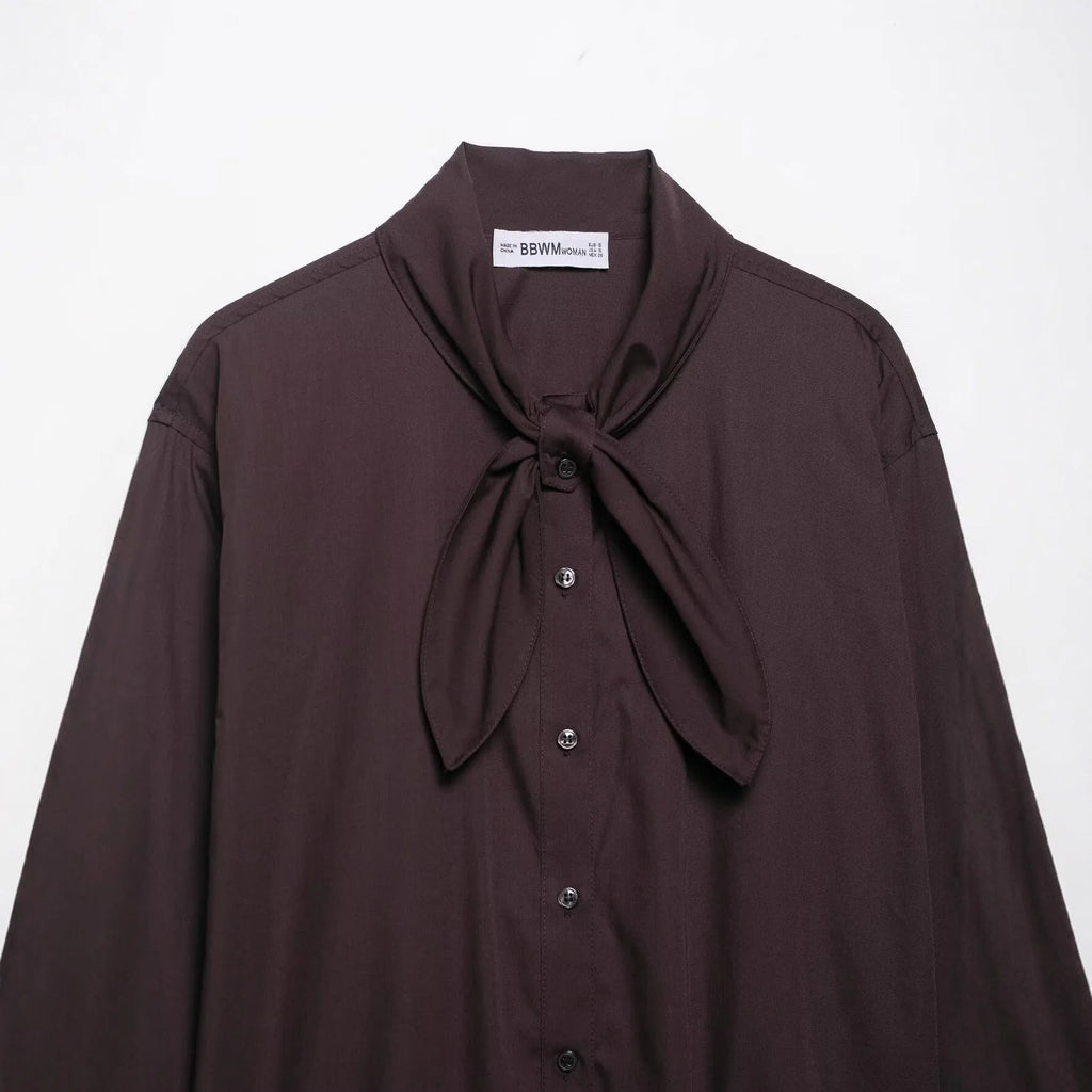 Brown women's poplin shirt with a bow tie, cardigan-style front, and long sleeves.