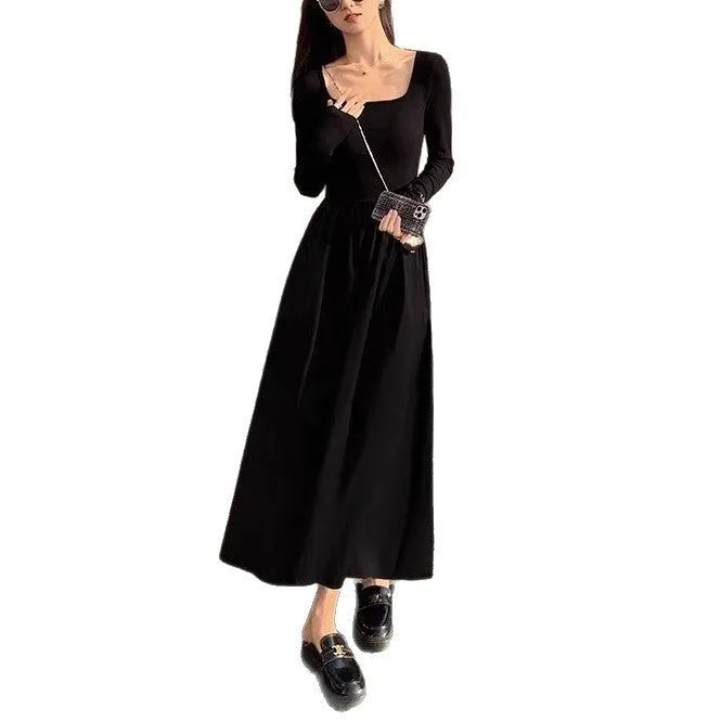 Women's black knitted dress with square collar and elastic waistband showing A-line long skirt design