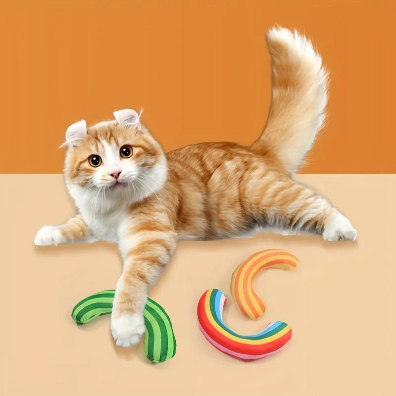 Green, rainbow, and yellow cat toy set with noise-maker, catnip, and a striped pillow measuring 23 by 20 cm.