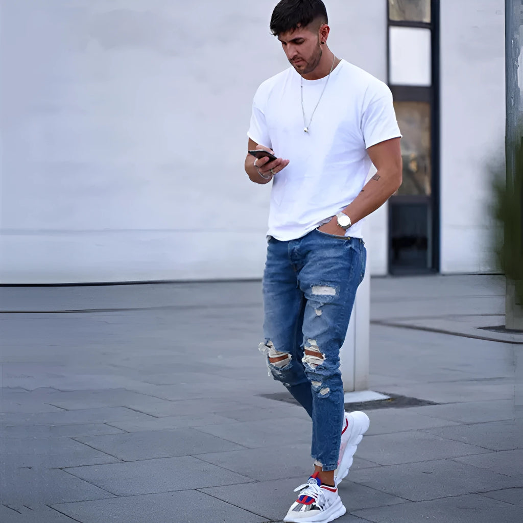 Men's deep blue cotton jeans laid flat, showing front detail and classic five-pocket design.
