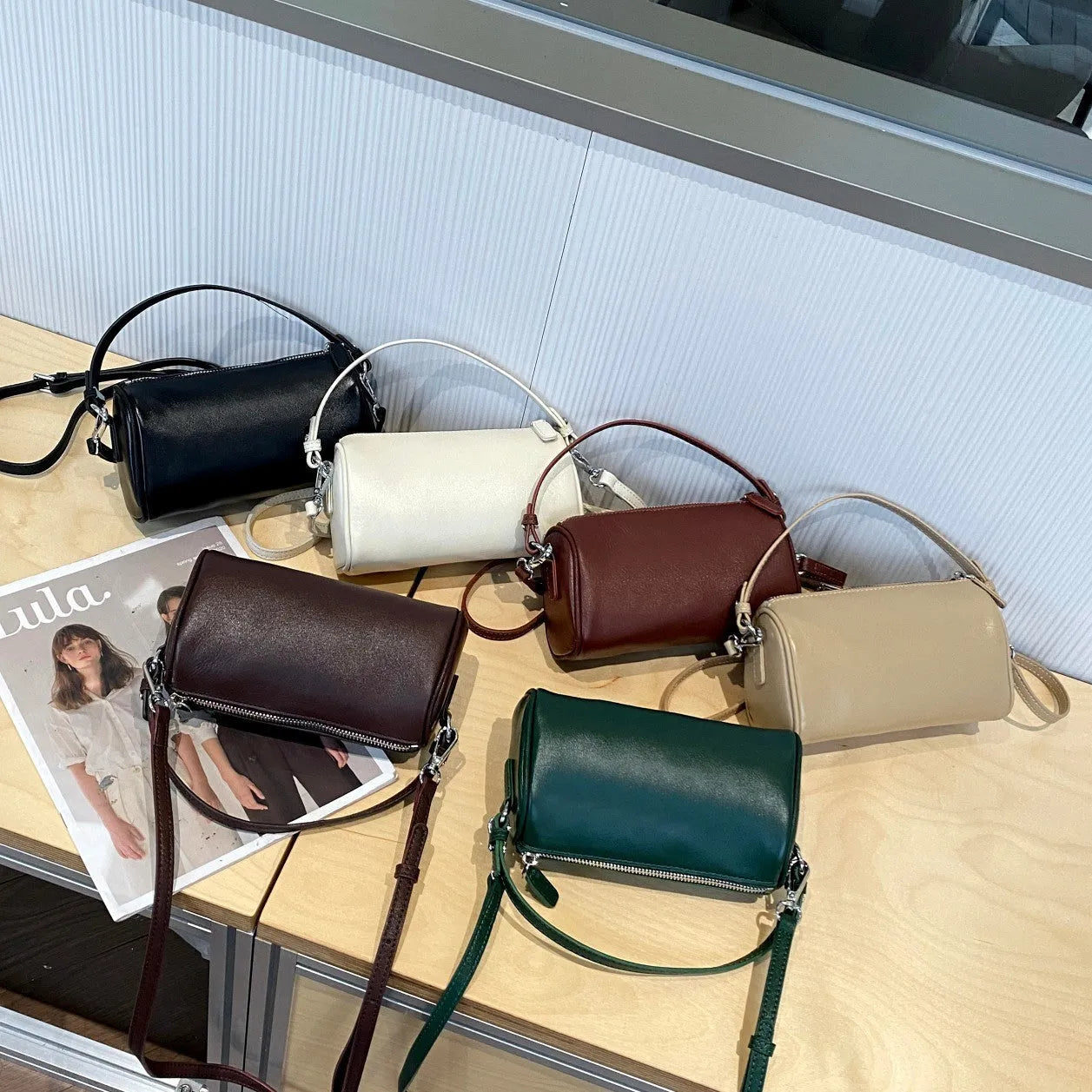 Soft genuine leather cylindrical crossbody phone bag in street style with sewing thread detailing