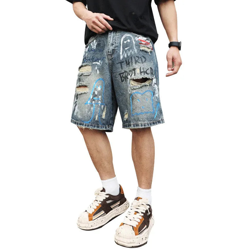 Blue ripped men's denim shorts with graffiti detail and a straight leg.