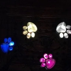 Black solar powered animal paw print LED garden lights set of four with solar panel pole
