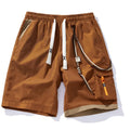 Man wearing loose-fitting black bamboo fibre sports shorts with a straight-leg cropped cut.
