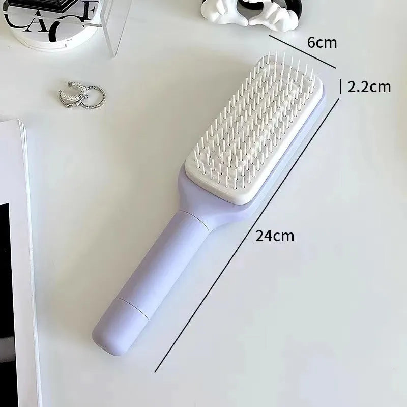 Self-cleaning hair brush with rotating handle, anti-static teeth and scalp massage points in purple and grey colours