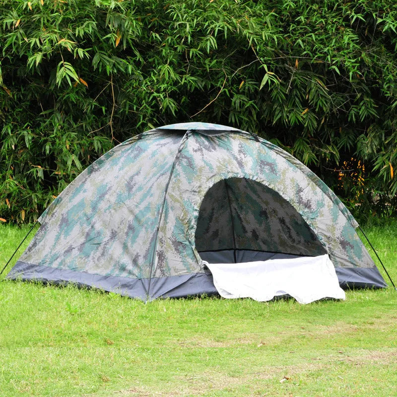 Double camouflage pattern tent pitched outdoors with triangular skylight visible