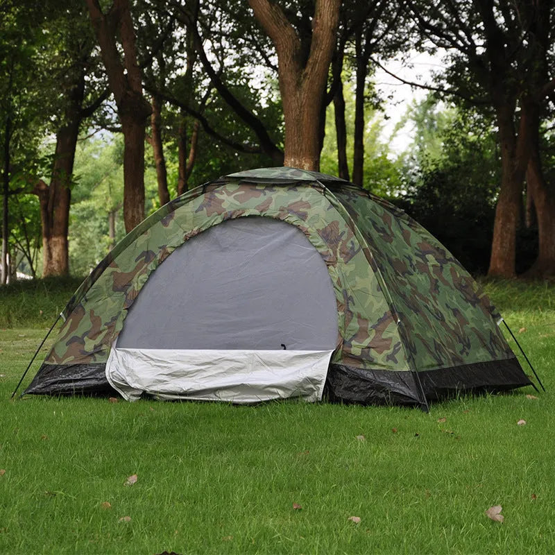 Double camouflage pattern tent pitched outdoors with triangular skylight visible