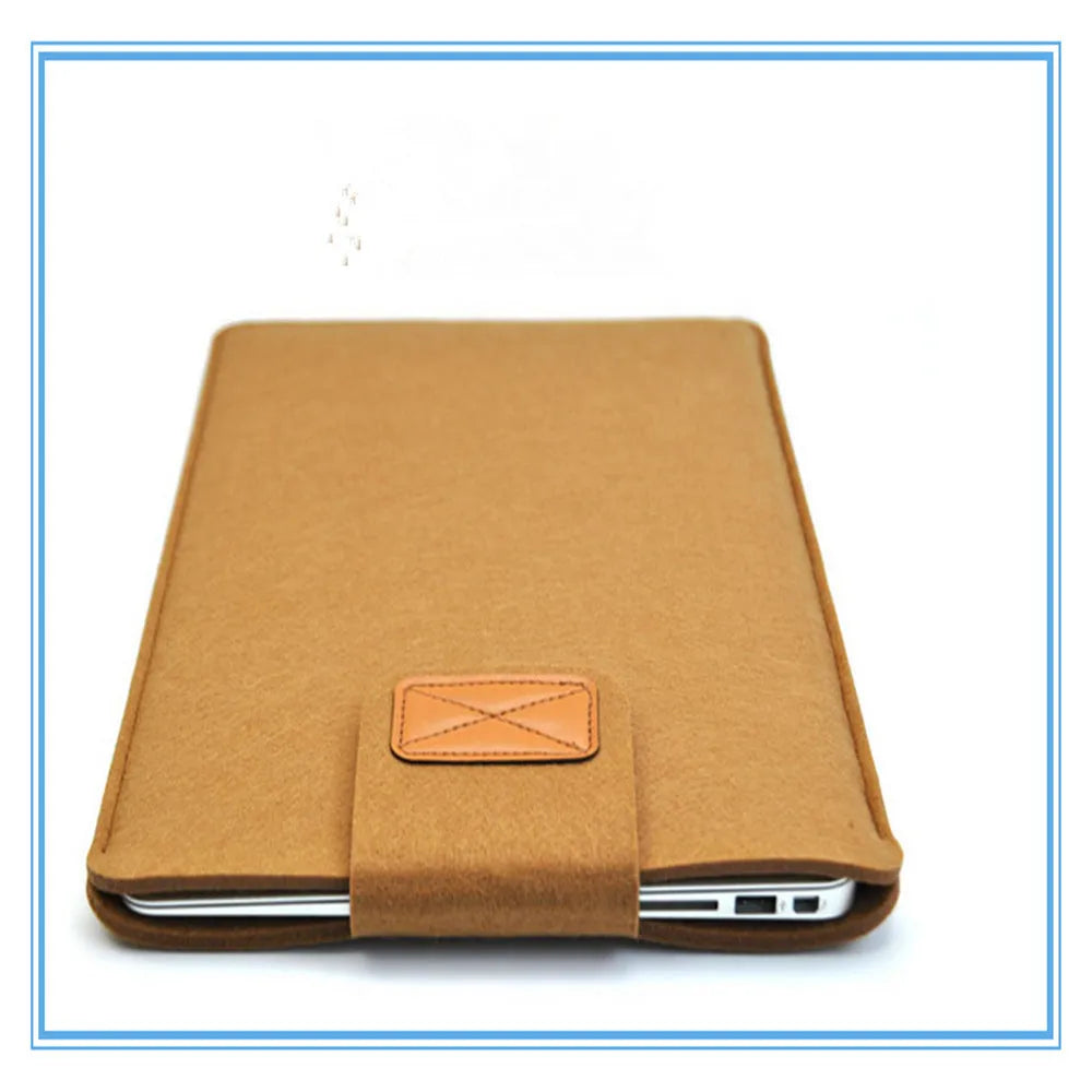 Dark grey clamshell laptop bag open to show interior laptop compartment and corner protector.