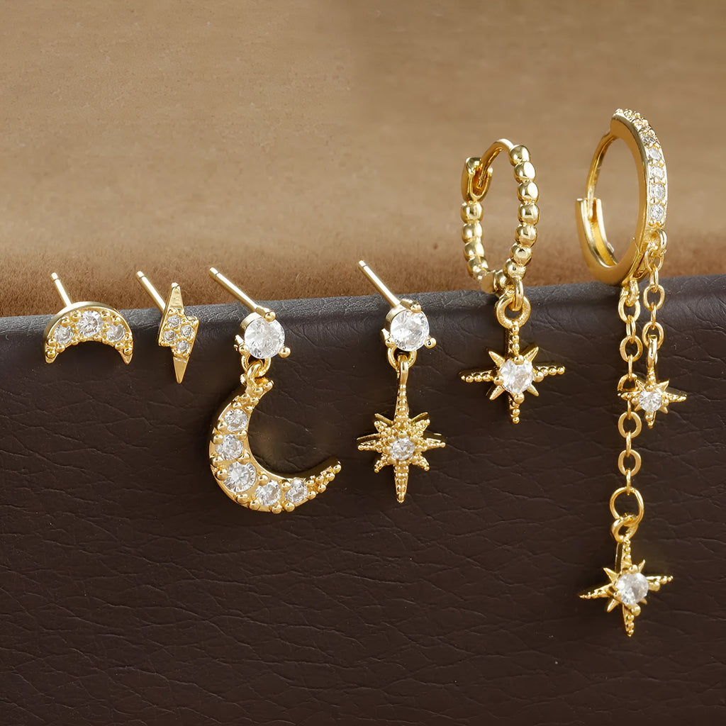 Six pairs of gold electroplated chain tassel earrings with zircon studs on display